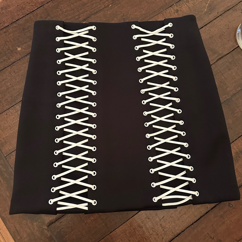 Mikhael Kale black mini skirt with white lace-up detail
